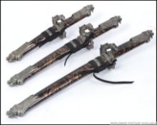 A collection of 3 20th century Japanese / Chinese daggers - short swords complete with scabbards