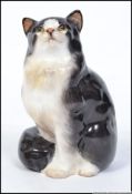 An Royal Doulton figure of a sitting cat ' Sitting Cat ',stamped to base with Doulton mark HN 999.