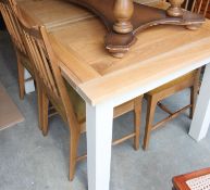 A country pine painted shabby chic dining table having a scrubbed pine top painted square legs