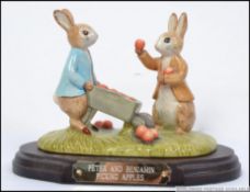 A Beswick Beatrix Potter figurine group Peter and Benjamin picking apples P4160 143/3000 on plinth