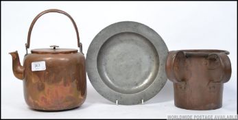 A Victorian copper twin handled mug of large form together with a copper kettle and a pewter plate