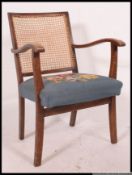 A 1930's mahogany and caned bergere library chair.
