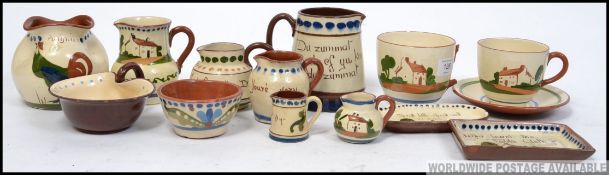 A collection of Torquay ware / motto ware to include jugs, dishes.