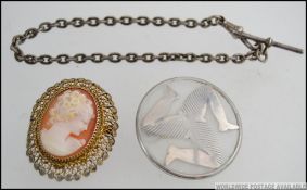 A smoked glass and silver overlaid Isle of man roundel brooch together with a silver bar and clasp