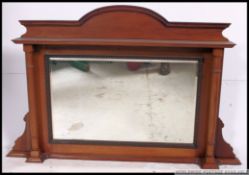 A Victorian mahogany armorial revival overmantel mirror.