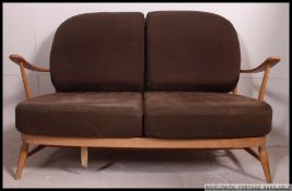 A 1970's retro Golden Dawn Ercol beech and elm Windsor pattern 2 seat sofa settee couch.