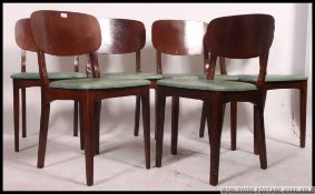 A good set of 6 butterfly back teak wood dining chairs being raised on shaped legs with vinyl