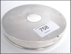 An hallmarked silver engine turned pot lid ( 10cm diameter ) having a London assay mark,