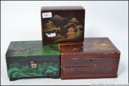A collection of Japanese laquered jewellery boxes each decorated with pagoda mountain scenes,