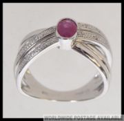 A modern 9ct white gold ( stamped 375 ) dress ring of cross over style,