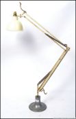 A Herbert Terry anglepoise lamp in cream with bell shade and raised on a later chrome base
