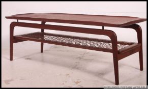 A 1960's retro Danish style teak wood suspension set coffee - occasional table raised on tapered