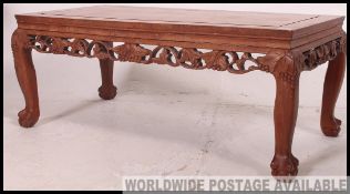 A 20th century Chinese hardwood coffee table raised on cabriole leg with pierced and carved frieze