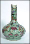 A 19th century Chinese famille rose celedon ground vase decorated with birds of paradise,