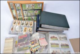 A really good box containing a collection of early 20th century cigarette cards,