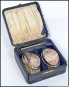 A cased silver hallmarked gentlemans vanity set comprising clothes brushes and comb .