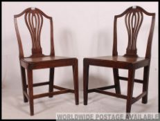 A 19th century oak pair of Chippendale revival north country hall chairs - dining chairs.