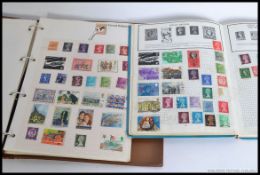 A collection of mid 20th century and later stamps from around the world contained in two albums