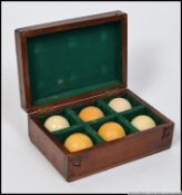 A Victorian mahogany cased set 5 Victorian snooker balls within a fabulous baize lined case.