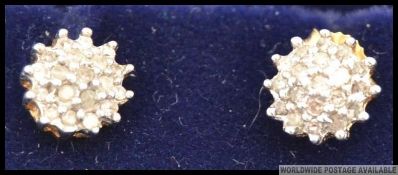 A pair of 9ct gold and cluster diamond stud earrings. The diamonds approx 15 pnts to each.
