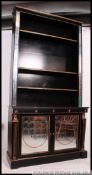 A large Regency revival ebonised gilt parcel library bookcase - pier cabinet.