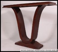 A 1930's Art Deco style console table raised on plinth base with scrolled supports and rectangular