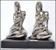 A pair of 20th century ceramic chrome style female figural bookend,
