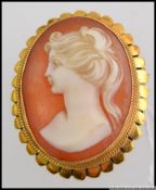 A stunning 18ct gold ladies shell cameo brooch with classical maiden study.