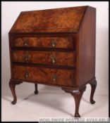 An excellent quality 1930's walnut queen anne bureau being raised on cabriole legs with fall front