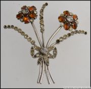 A ladies silver and marcasite amber brooch in the form of flowers having central marcasite bow,