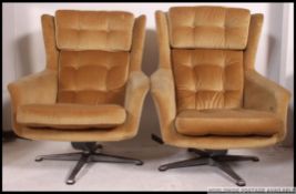 A pair of original retro G Plan 1960's swivel / rocking egg shape danish inspired armchairs,