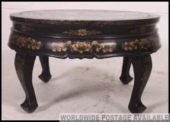 A stunning Chinese lacquer and ebonised circular coffee table,