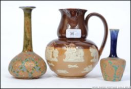 A Doulton Lambeth relief moulded stoneware harvest jug along with two Royal Doulton Slaters patent