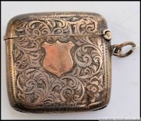 A silver and 9ct gold hallmarked vesa being rococo chased with 375 gold marked plain cartouche to