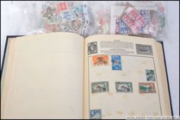 A vintage Amherst stamp album, filled with assorted overseas / foreign vintage stamps,