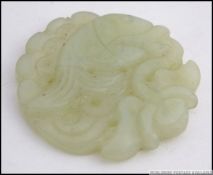 A Chinese Jade roundel carving of a fish in the sea ( see illustrations ) W6cm