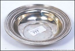 A silver Sterling wine coaster by Reed & Barton with ball bead work borders ( stamped to the base )