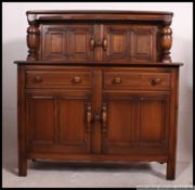 An Ercol Golden Dawn beech and elm wood court cupboard sideboard.