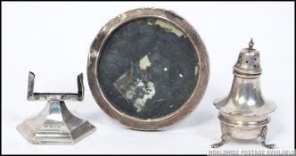 A silver hallmarked pepperpot by Walker & Hall together with a Chester hallmarked silver desk top