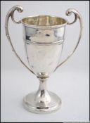 A silver hallmarked twin handled cup ( 14CM TALL ) bearing assay marks for Birmingham,