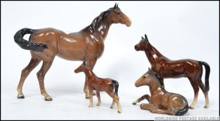 A collection of Beswick horse figurines to include large and 3 small. 2 marked Beswick, 2 unmarked.