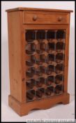 A country pine 20th century wine rack cabinet. The central rack with drawers above.