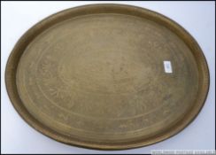 A fabulous early 20th century large and very heavy brass oval shaped tray of asiatic origin being