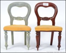 A pair of apprentice piece mahogany balloon back dining chairs, one being shabby chic painted.