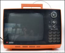 A retro 1970's portable Hitachi television, having a plastic orange body,