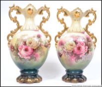 A pair of 19th century pair of Staffordshire floral transfer printed twin gilt handled ewers,