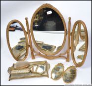 A 20th Century dressing table set of gilt filigree design along with a triptych mirror of similar