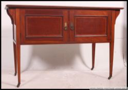 An Edwardian mahogany washstand cabinet being raised on squared legs with a double door cupboard.