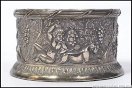 A 19th century silver plated wine coaster moulded in relief with grape and vine with cherubs