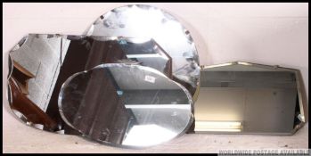 A collection of four 1930's Art Deco Odeon style frameless wall mirrors having bevelled edges to